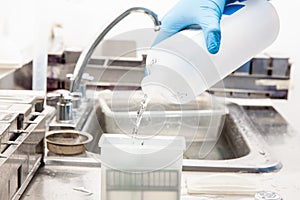 Scientist preparing slides with paraffin embedded tissue samples for immunohistochemistry assay in the laboratory photo
