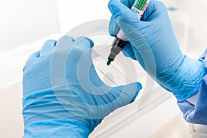 Scientist preparing slides with paraffin embedded tissue samples for immunohistochemistry assay in the laboratory photo