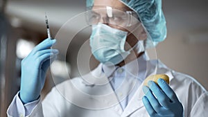 Scientist preparing syringe for adding pesticides and nitrates in potato sample photo