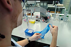 Scientist professor putting on his gloves