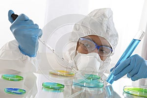 Scientist in Protective Clothing in Lab