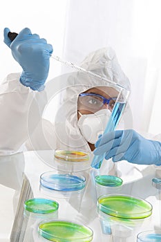 Scientist in Protective Clothing in Lab