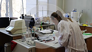 Scientist puts samples with DNA fragments into agarose gel for separation of DNA fragments for electrophoresis