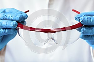 Scientist putting on safety goggles to start a job