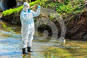 a scientist with a sample of contaminated contaminated water with a walkie-talkie warns about environmental