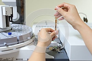 Scientist shooting a sample in the analytical instrument photo