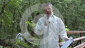 Scientist speaking microphone in woods