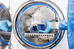 Scientist sterilizing laboratory material