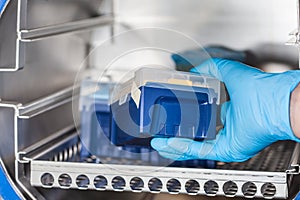 Scientist sterilizing laboratory material