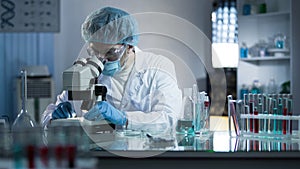 Scientist studying dna branches for additional information in cloning process photo