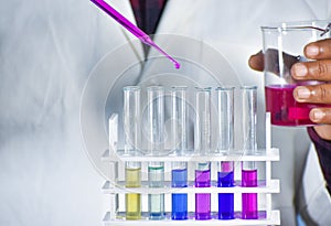 Scientist taking color solution in a test tube