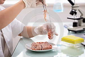 Scientist Taking Sample Of Meat In Test Tube
