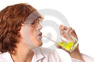 Scientist tasting liquid from a beaker