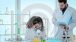 Scientist team use microscope in the lab. Biotechnology researcher scientist working look microscope in the medical development