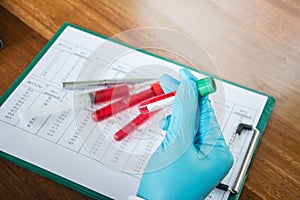 Scientist with test tube making research in clinical laboratory.