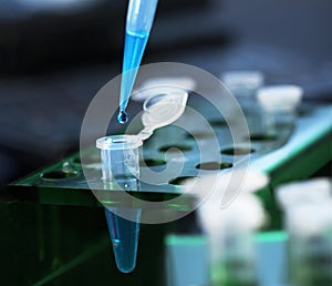 scientist with test tubes and flasks conducting an experiment in a science lab