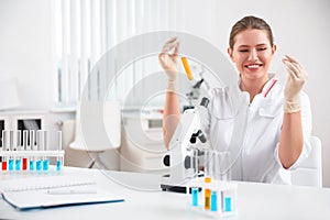 Scientist with test tubes and microscope. Medical research