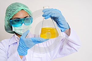 Scientist in uniform holding beaker and test tube have chemical liquid