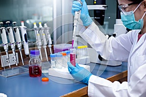 Scientist use a micropipette with sample preparation in the laboratory photo