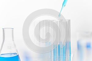 Scientist use pipette drops chemical liquid in test tube in laboratory