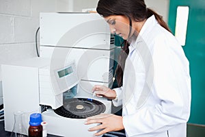 Scientist using a centrifuge