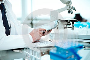 scientist using a digital tablet in a science lab .