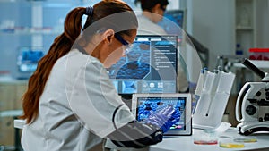 Scientist using digital tablet working in modern medical research laboratory