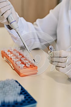 Scientist using Eppendorf micropipette transfer sample