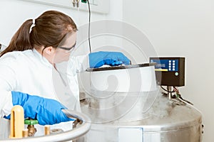 Scientist using liquid nitrogen machinery