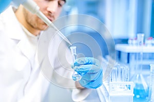 Scientist using medical tool for extraction of liquid from samples in special laboratory or medical room