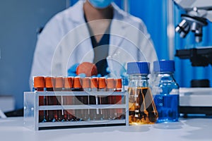 Scientist using microscope in laboratory. Close-up of a researcher& x27;s hands adjusting microscope in lab setting. Scienc