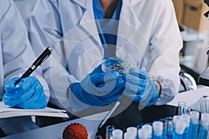 Scientist using microscope in laboratory. Close-up of a researcher& x27;s hands adjusting microscope in lab setting. Scienc