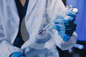 Scientist using microscope in laboratory. Close-up of a researcher& x27;s hands adjusting a microscope in a lab setting. Scienc