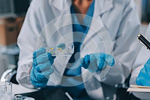 Scientist using microscope in laboratory. Close-up of a researcher& x27;s hands adjusting a microscope in a lab setting.