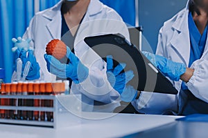 Scientist using microscope in laboratory. Close-up of a researcher& x27;s hands adjusting microscope in lab setting. Scienc