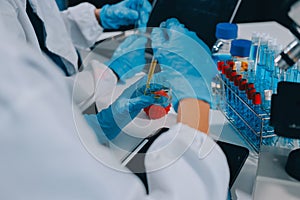 Scientist using microscope in laboratory. Close-up of a researcher& x27;s hands adjusting a microscope in a lab setting.