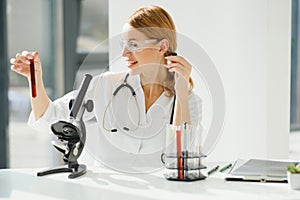 Scientist using a microscope in a laboratory, Testing for Coronavirus Covid19 vaccine