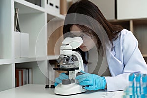 Scientist Using Microscope in Modern Laboratory for Research and Analysis