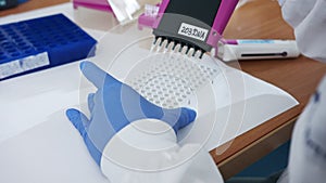 Scientist using a multichannel Pipette to collect samples in a chemistry lab