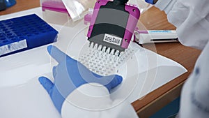 Scientist using a multichannel Pipette to collect samples in a chemistry lab