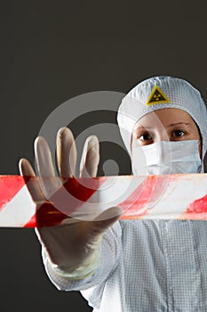 Scientist in white protective suit, prohibits entry to the territory