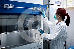 Scientist woman checking the fume hood in the laboratory