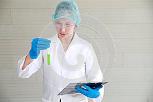 Scientist woman checking and recording the results using as science research background