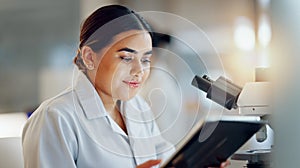 Scientist, woman and tablet, microscope or laboratory research for DNA analysis and happy with medical study. Student or