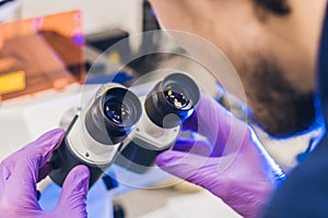 Scientist work on a confocal scanning microscope in a laboratory for biological samples investigation