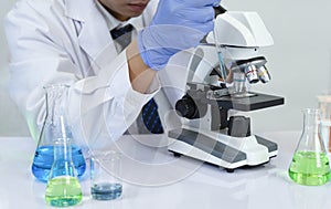 Scientist working in chemical laboratory,doing chemistry experiments with microscope