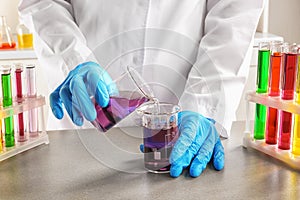 Scientist working with color sample in laboratory, closeup