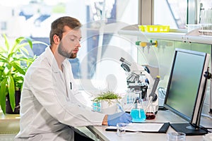 Scientist working in lab. Doctor making microbiology research. Laboratory tools: microscope, test tubes, equipment