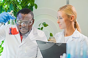 Scientist working in lab. Doctors making medical research. Laboratory tools: microscope, test tubes, equipment