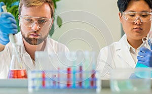 Scientist working in lab. Doctors making medical research. Laboratory tools: microscope, test tubes, equipment